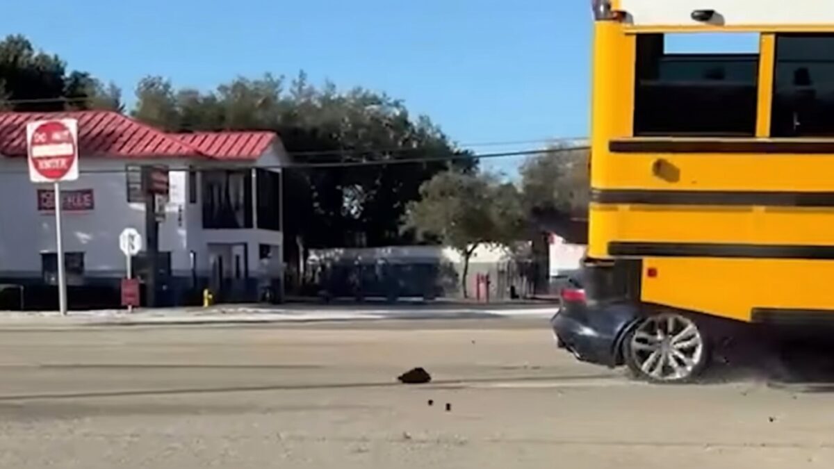 Un șofer de Jaguar F-Type a scăpat cu viață după ce a intrat sub un autobuz școlar